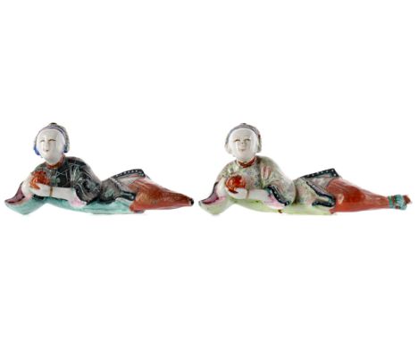 TWO EARLY 20TH CENTURY CHINESE CERAMIC FIGURES, each modelled as a reclining male holding a fruit/pot, 14cm and 13cm long