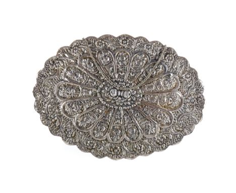 INDIAN WHITE METAL WALL MIRROR, the oval mirror embossed to the reverse with an abundance of flowers, 30.5cm wide