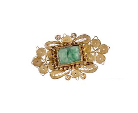 CHINESE JADE SET BROOCH, the silver gilt filigree in stylised floral shapes, inset with a rectangular jade carving, 5cm wide