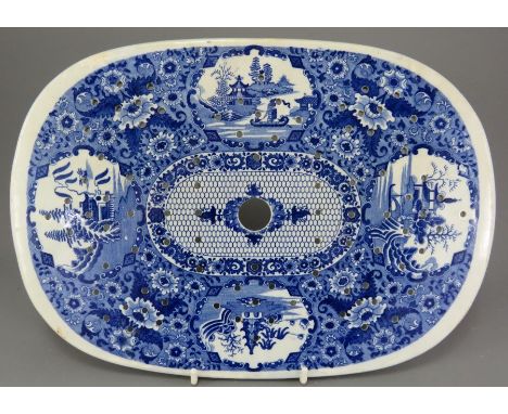 An early nineteenth century blue and white transfer-printed Spode Net pattern large drainer, c. 1815. It is marked to the und
