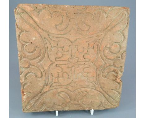 A German medieval floor tile from the fourteenth century. It is decorated with an impressed a geometric design. 22 cm wide. (