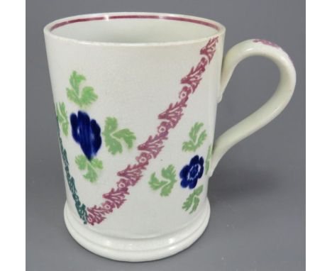 An early nineteenth century pearlware spongeware tankard, tri-colour decorated in green, blue and pink, c. 1825-40. It is unm