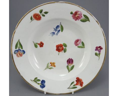 An nineteenth century porcelain hand-painted soup dish, c. 1810-20. It is decorated with a variety of different floral sprays