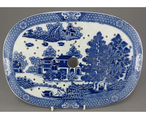 An early nineteenth century blue and white transfer-printed Spode Forest Landscape pattern drainer, c. 1810.It is unmarked to