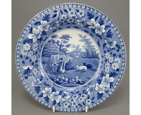 An early nineteenth century blue and white transfer-printed Spode Milkmaid pattern soup dish, c. 1825. It is marked to the un