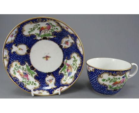 A late eighteenth century hand-painted plate blue scale and pheasant pattern cup and saucer, c. 1790. It depicts alternating 