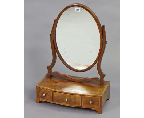 A 19th century inlaid-mahogany oval swing toilet mirror fitted three small drawers to the bow-front box-base, &amp; on bracke