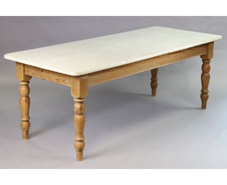 A pine farmhouse table with light grey painted rectangular top having rounded corners, the natural underside on four baluster