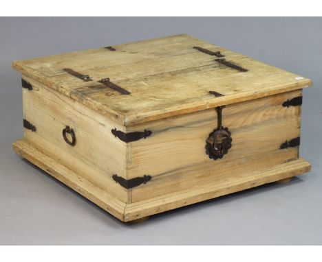 A Mexican pine &amp; iron-bound large square storage trunk with a double hinged lift-lid, iron ring side handles, &amp; on bu
