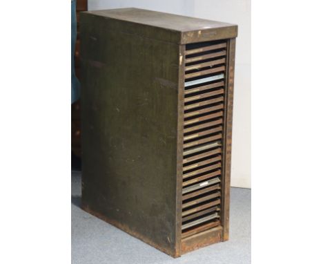 A vintage grey metal small upright office cabinet bears plaque “John Haddon &amp; Co. of London” fitted twenty-five sliding t