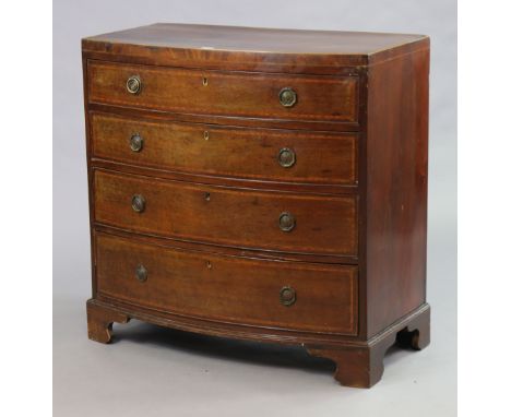 An early 19th century inlaid-mahogany small bow-front chest fitted four long graduated drawers with brass ring handles, &amp;