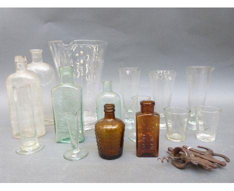 A quantity of medical/laboratory glassware to include conical measures with Government stamp, cylindrical examples, medicine 