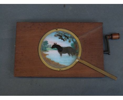 Two late 19th/20th century magic lantern slides to include a hand turned kaleidoscope example and a horse drinking from a str