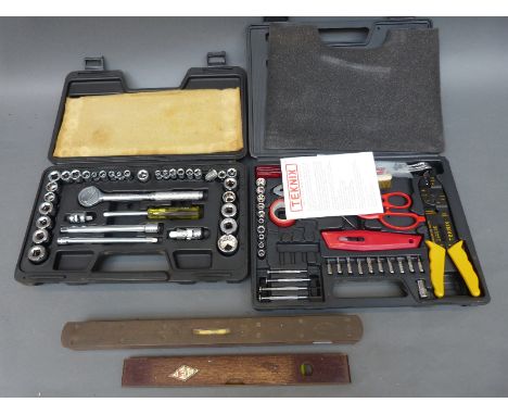 A vintage Rabone level another brass topped level and two sets of tools in cases