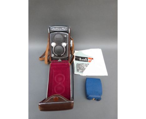 A cased Yashica-mat TLR camera, manual and a Rotolux light meter