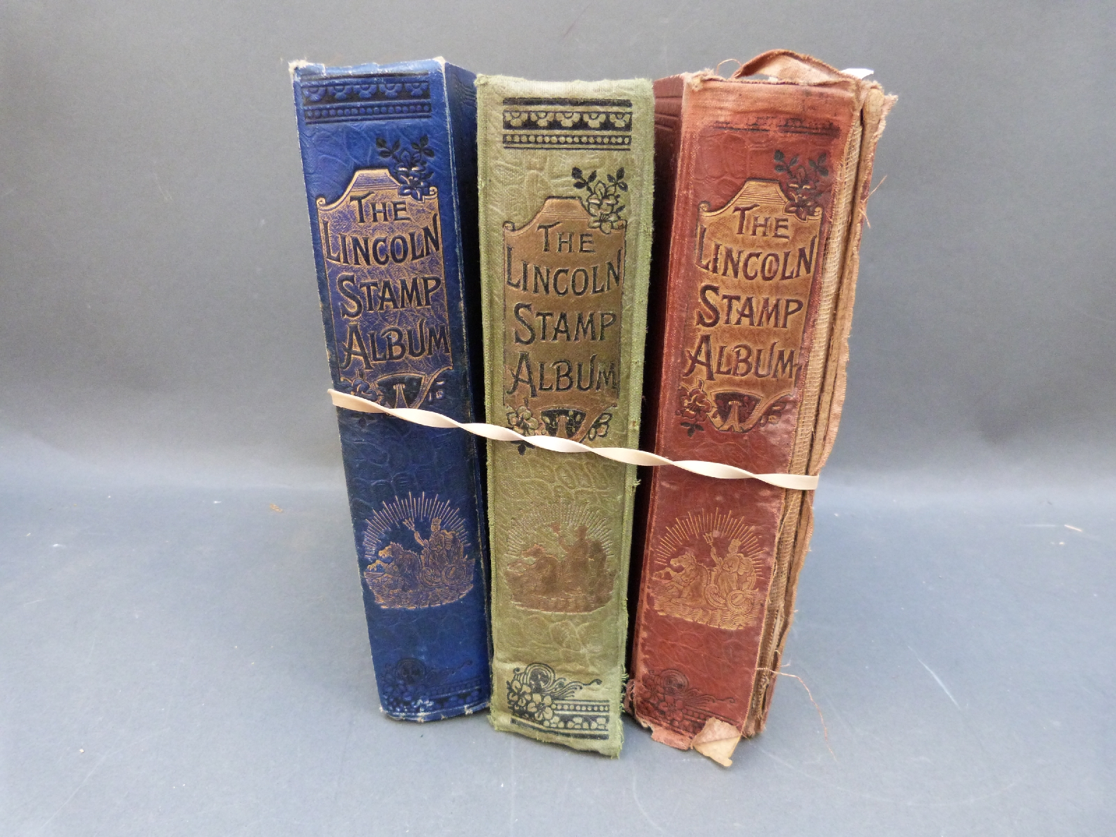 Three old Lincoln stamp albums, well filled with allworld stamps