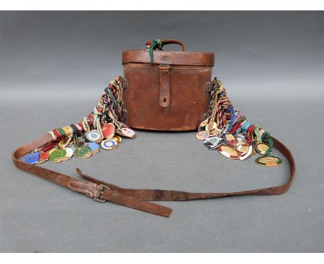Approximately 65 enamel horse racing pendants, mainly Sandown Park and Ascot circa 1950-80 all attached to a vintage military