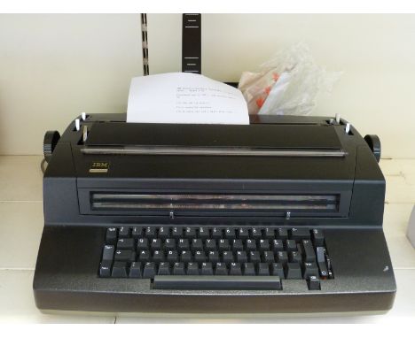 A vintage IBM 'golfball' typewriter model 670 with extra balls and cover