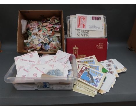 A large quantity of loose all-world stamps, first day covers etc
