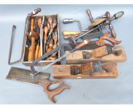 A quantity of vintage woodworking tools to include planes, drill, saw, chisels etc