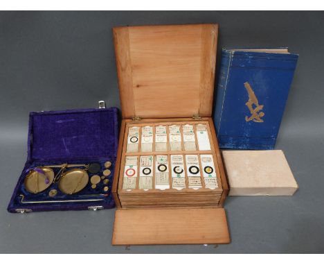 A cased set of microscope slides comprising twelve trays of largely botanical, insects and fish sample sections, together wit