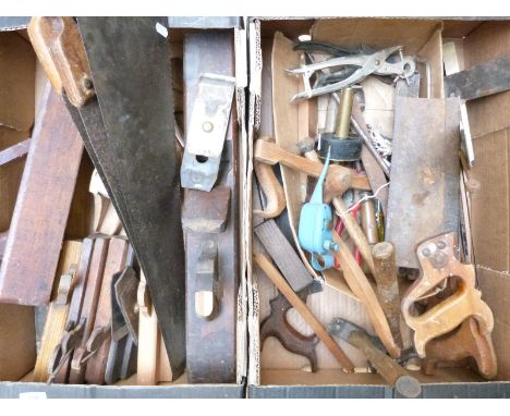 A collection of vintage woodworking tools including large block planes, brass inlaid scribe and set squares, saws, brass plum