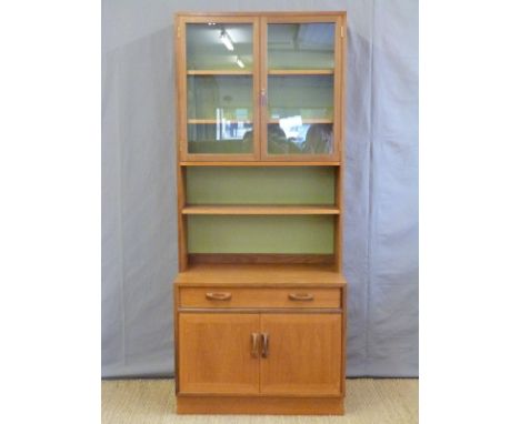 A retro glazed G Plan bookcase with shelf under, single drawer and two cupboard drawers (H200 x W84 x D46cm)