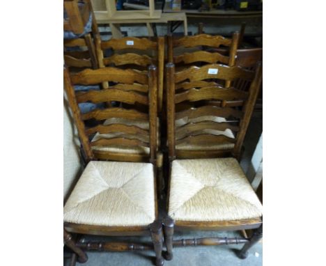 A set of four Brights of Nettlebed oak ladder-back chairs