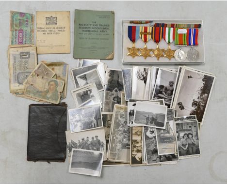 A collection of medals and items belonging to a soldier, including a group of medals including Africa Star with 8th Army bar,