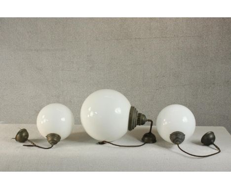 A set of three Victorian style contemporary hanging globe lights, with milk glass shades and bronzed metal fittings. Dia. 14c