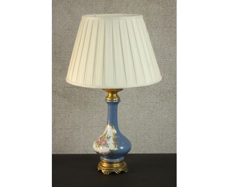 A hand painted and gilded porcelain floral design lamp on a gilt metal repousse design stand. H.77 Dia.45cm. 