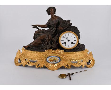 A French gilt ormolu and spelter Classical lady design mantle clock on a gilt pierced foliate base, white enamel dial with bl