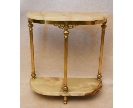 A circa 1970s brass and onyx console table of demi lune form, the onyx top and undertier with a moulded edge, on three fluted