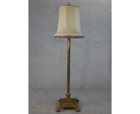 A Victorian brass fluted column design floor lamp with square base on four lion paw feet. H.170 W.38 D.38cm 