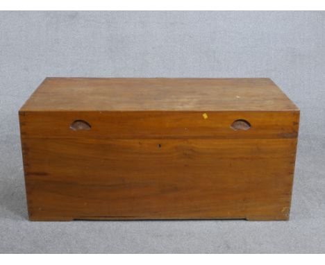 A 19th century camphor wood campaign trunk, of rectangular form with recessed handles to the lid and iron handles to the side