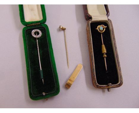 A 9ct yellow gold money clip and three 9ct gold tie pins set with diamonds and an opal