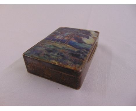 A silver rectangular snuff box, the hinged cover enamelled with trees in a landscape, Chester 1932 A/F