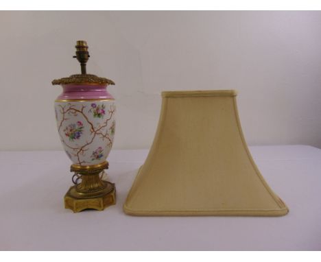 A gilt metal and porcelain table lamp, ovoid form on hexagonal base with silk shade