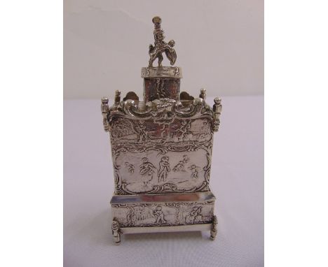 A late 19th century Dutch silver tea caddy rectangular form chased with figures and putti, the domed pull off cover with lion