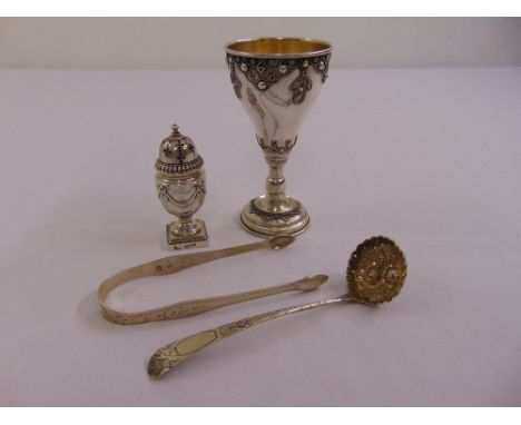 A silver pepperette, a pair of Hester Bateman sugar tongs, a Continental white metal goblet and a sauce ladle
