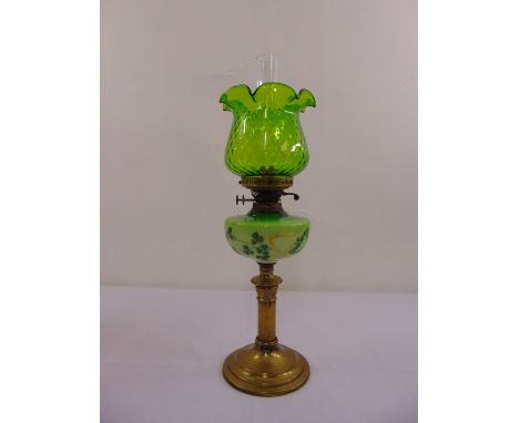 A green glass oil lamp on cylindrical stem and raised circular base