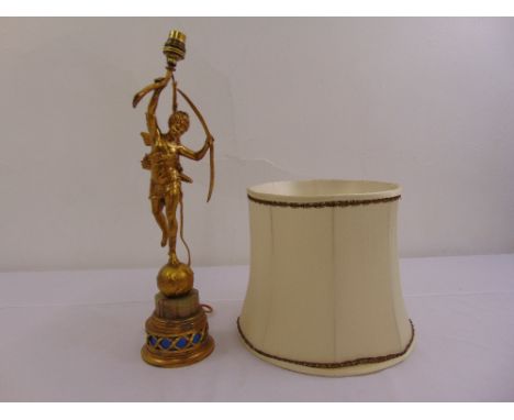 A gilt metal and onyx table lamp in the form of a classical figurine on raised cylindrical base