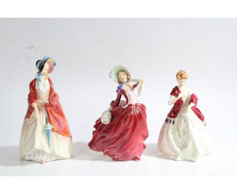 Two Royal Doulton figurines 'Paisley Shawl' and 'Autumn Breezes' and a Royal Worcester figurine 'First Dance' modelled by F. 