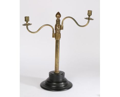 Gothic style two branch brass candelabra, with a pair of adjustable arms attached to a cylindrical column raised on a black p