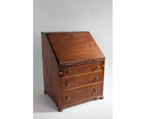 A 19th Century mahogany miniature bureau, the fall above three long drawers, on ogee bracket feet, 27cm wide, 36cm high, 22cm