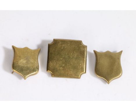Brass escutcheons from a wooden trunk, two shield shaped, the third a square with notched corners, shields 5 cm x 4.3 cm, squ