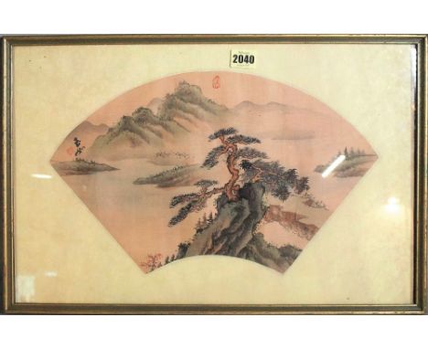 A Chinese fan painting, watercolour on silk, painted with a pine tree on a rocky outcrop before a mountainous river landscape