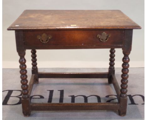 An 18th century oak single drawer low side table on bobbin turned supports, 77cm wide x 63cm high.