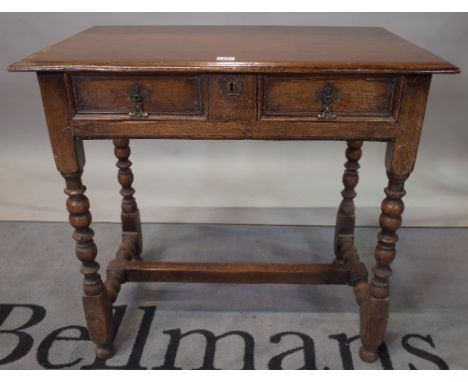 An 18th century style oak single drawer side table on bobbin turned supports, 79cm wide x 73cm high. 