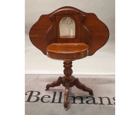 A Dutch mahogany and walnut combined centre table and dressing table, circa 1840, the serpentine outline tilt-top enclosing a